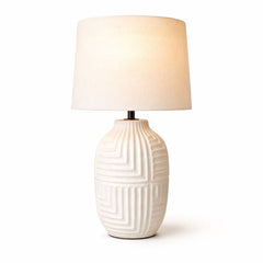 A refined glossy white ceramic table lamp with smooth sculpted silhouette