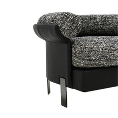 Close-up of the Elias Armchair showcasing its textured woven upholstery and smooth leather exterior, emphasizing premium craftsmanship and tactile contrast.