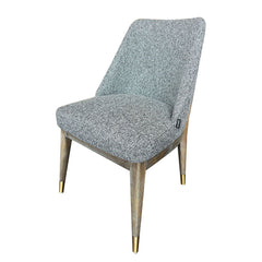 Elin Dining Chair with ergonomic scoop back, slightly raised sides, foam cushioning, and gold-accented rubberwood legs for stylish and comfortable seating.
