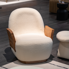Comfortable modern reading chair with chenille fabric, curved backrest, and warm wooden side details.