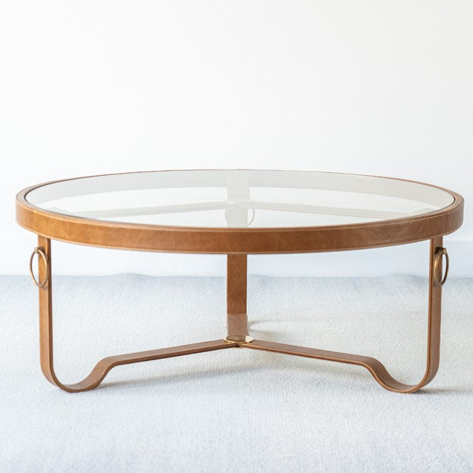 Round glass and leather coffee table with metal accents