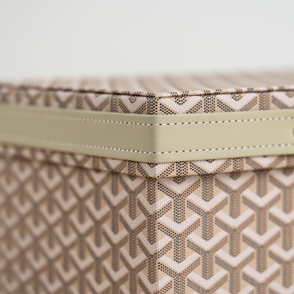 Sophisticated home organizer with woven texture and gold metal clasp.