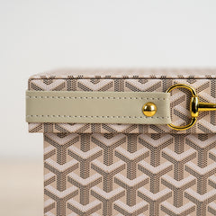 Sophisticated home organizer with woven texture and gold metal clasp.