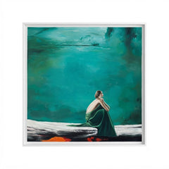 A framed square art print featuring an abstract painting of a seated woman in green and white against a dominant teal and green background, shown on a light gray backdrop.