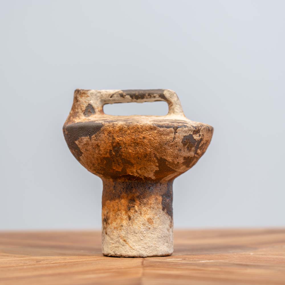 Small textured stoneware vase with an irregular wabi-sabi design, featuring metallic accents and light glaze for a natural, rustic look.
