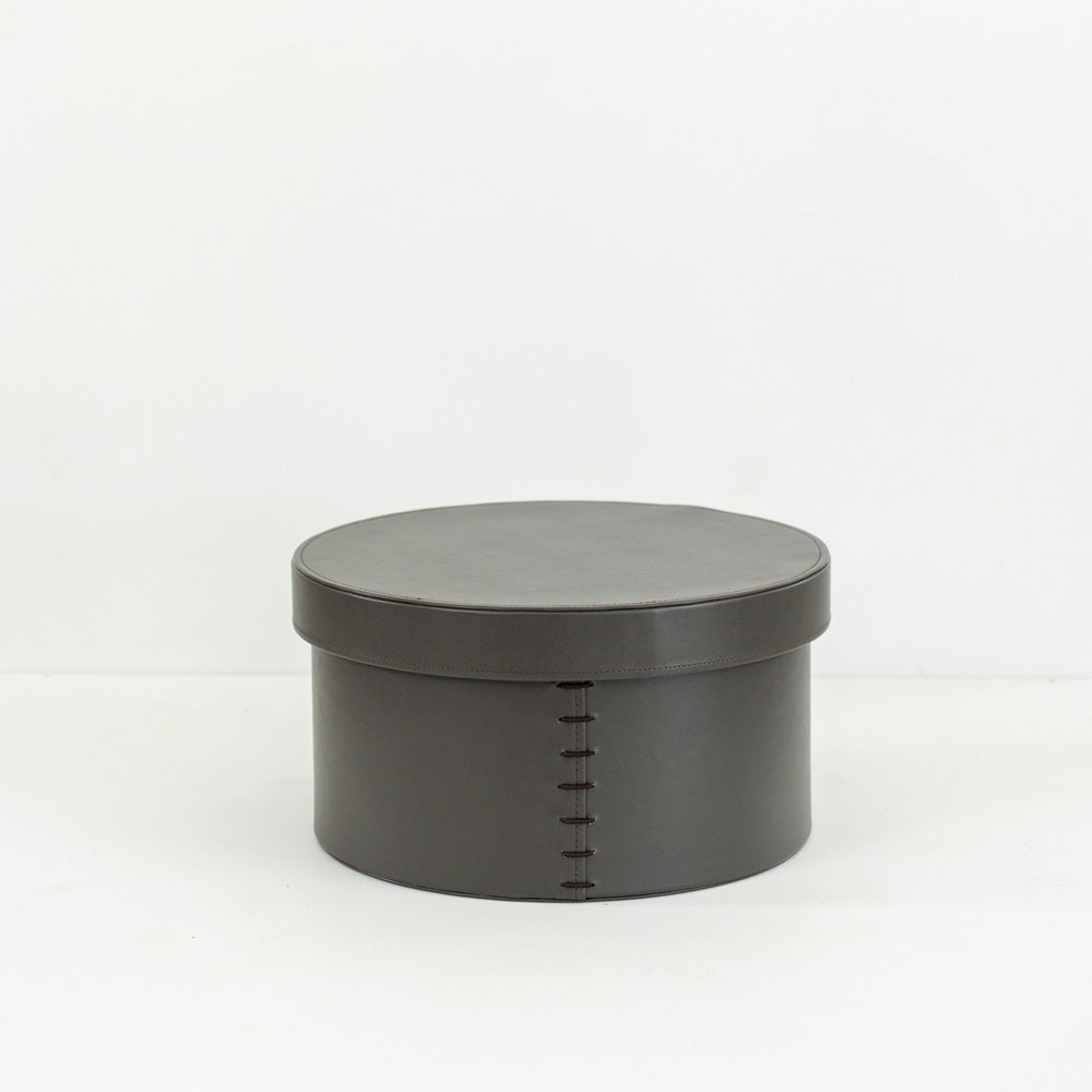 Stylish hand-woven bridle leather round box, offering practical storage and a sophisticated touch to living rooms, bedrooms, or offices in contemporary and minimalist spaces.