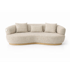 Modern curved 3 seater sofa upholstered in beige textured fabric, featuring a sculptural silhouette and comfortable deep seating ideal for contemporary living rooms.