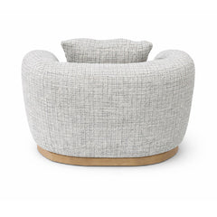 Designer armchair in grey textured upholstery with a smooth curved form, ideal as a statement seating piece for modern homes and interiors.