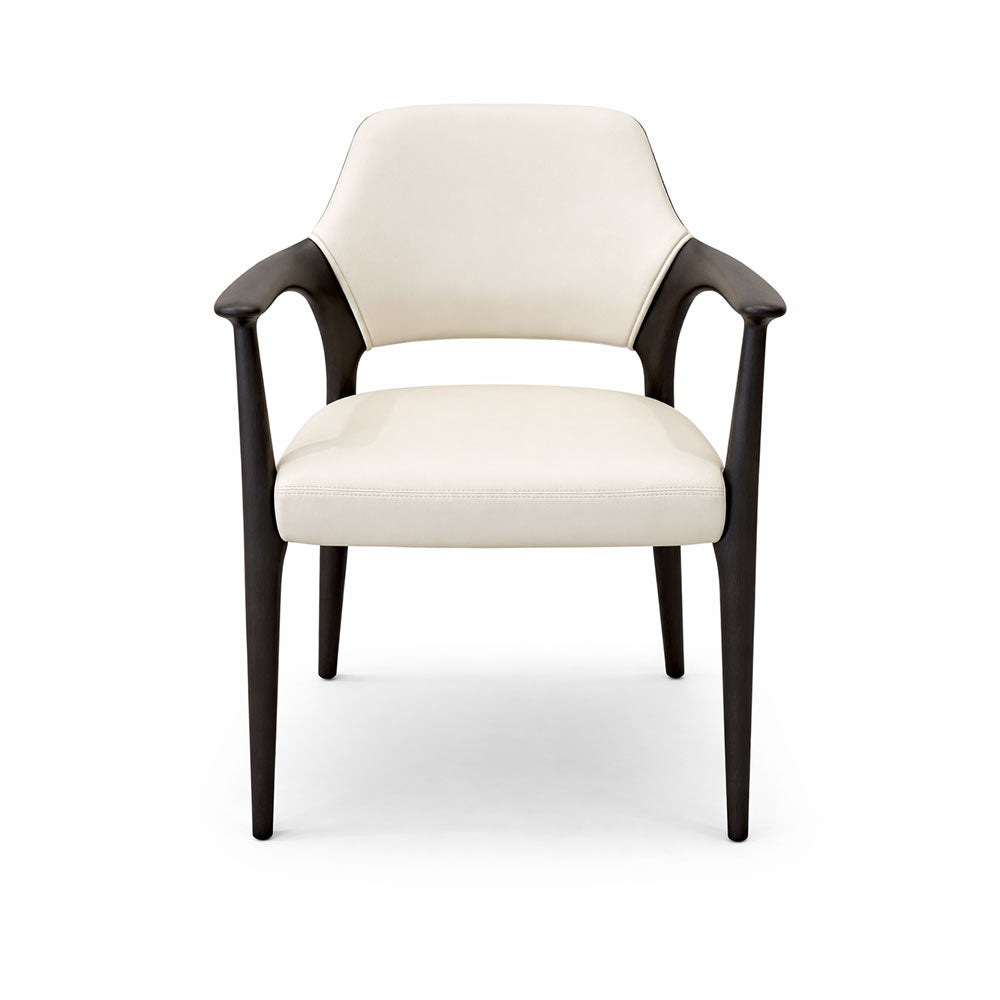 Modern dining chair upholstered in cream microfiber leather, featuring elegantly shaped contrasting legs for a stylish and comfortable seating option.
