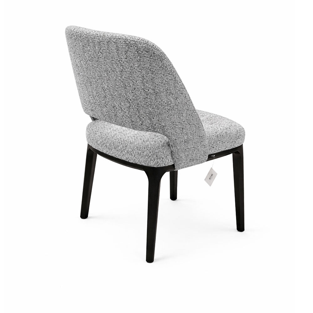 Refined grey upholstered dining chair with clean lines, subtle backrest detail, and durable dark-colored legs, ideal for stylish dining spaces.