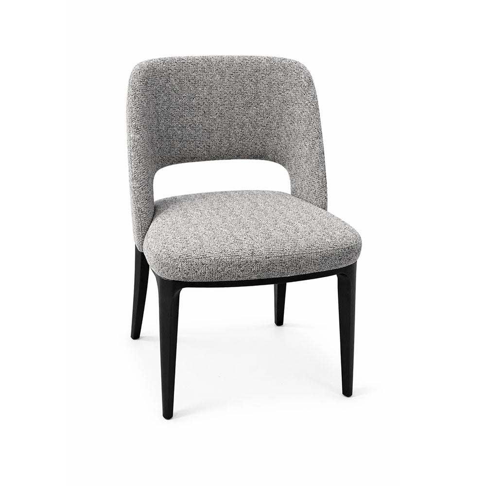 Classic dining chair with traditional square back, slightly rounded edges, and subtle backrest opening, upholstered in soft grey fabric with dark legs.