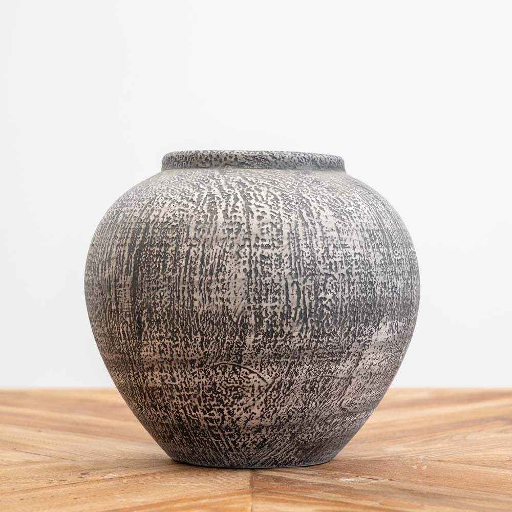 Handcrafted textured ceramic vase with an organic rounded shape and earthy glaze, ideal for modern, boho, and rustic home décor.