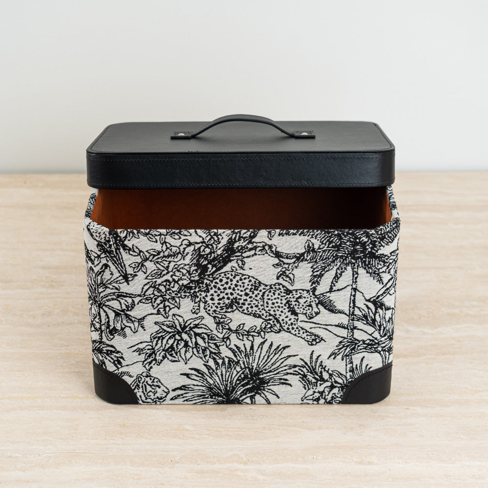 Functional and artistic storage organizer featuring a black lid and exotic print body.