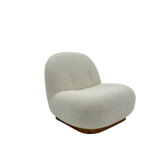 Designer accent chair upholstered in soft white boucl?? with a sculptural, low-slung profile and sleek metallic legs.