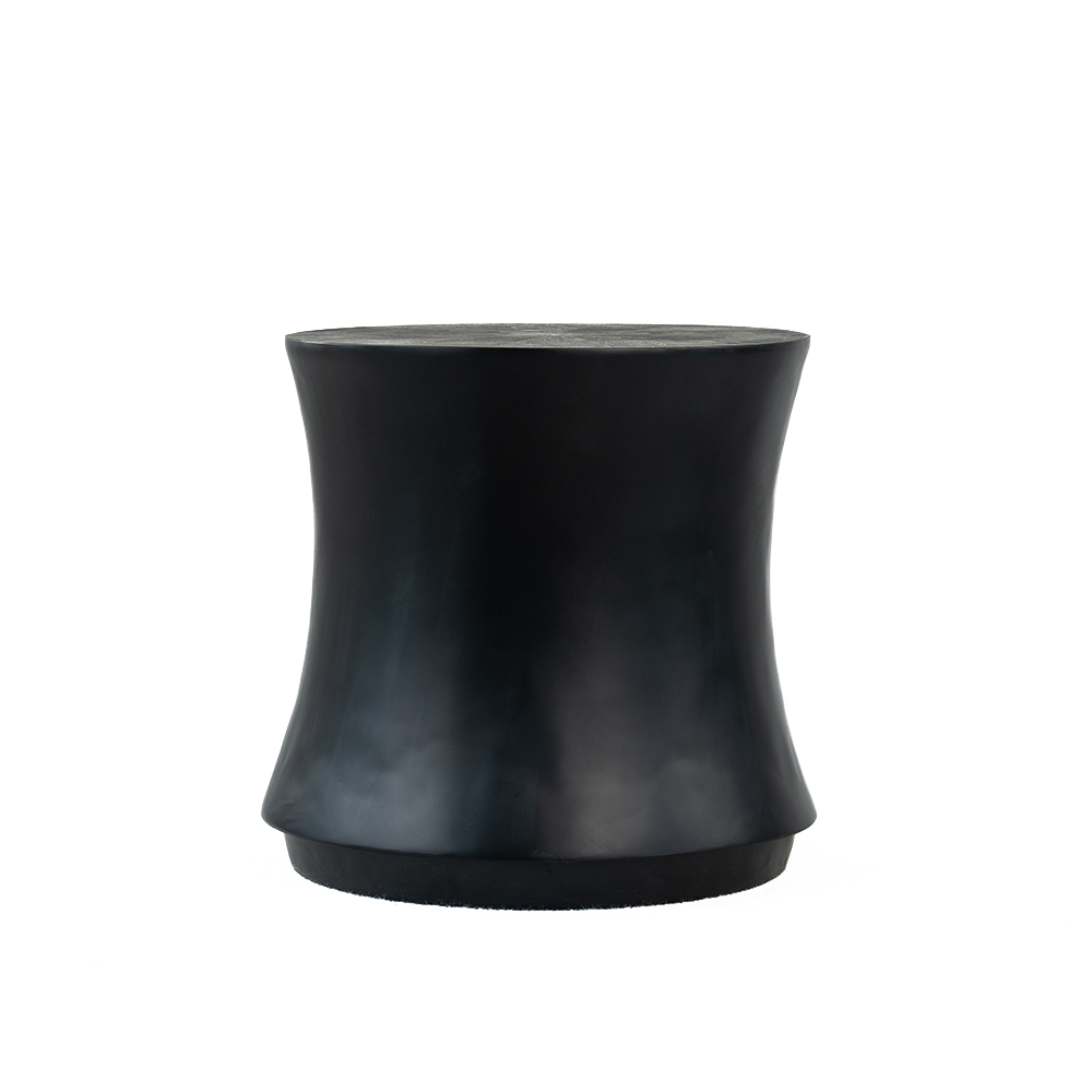 Modern side table made of warm wood veneer with a minimalist design, styled next to a sofa in a contemporary living room setting.