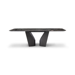 Close-up of the Otto Dining Table showing its diamond marble countertop with natural veining and the bold black base in a modern dining room.