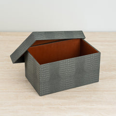 Decorative organizer box in dusty blue crocodile texture with bold orange velvet inside