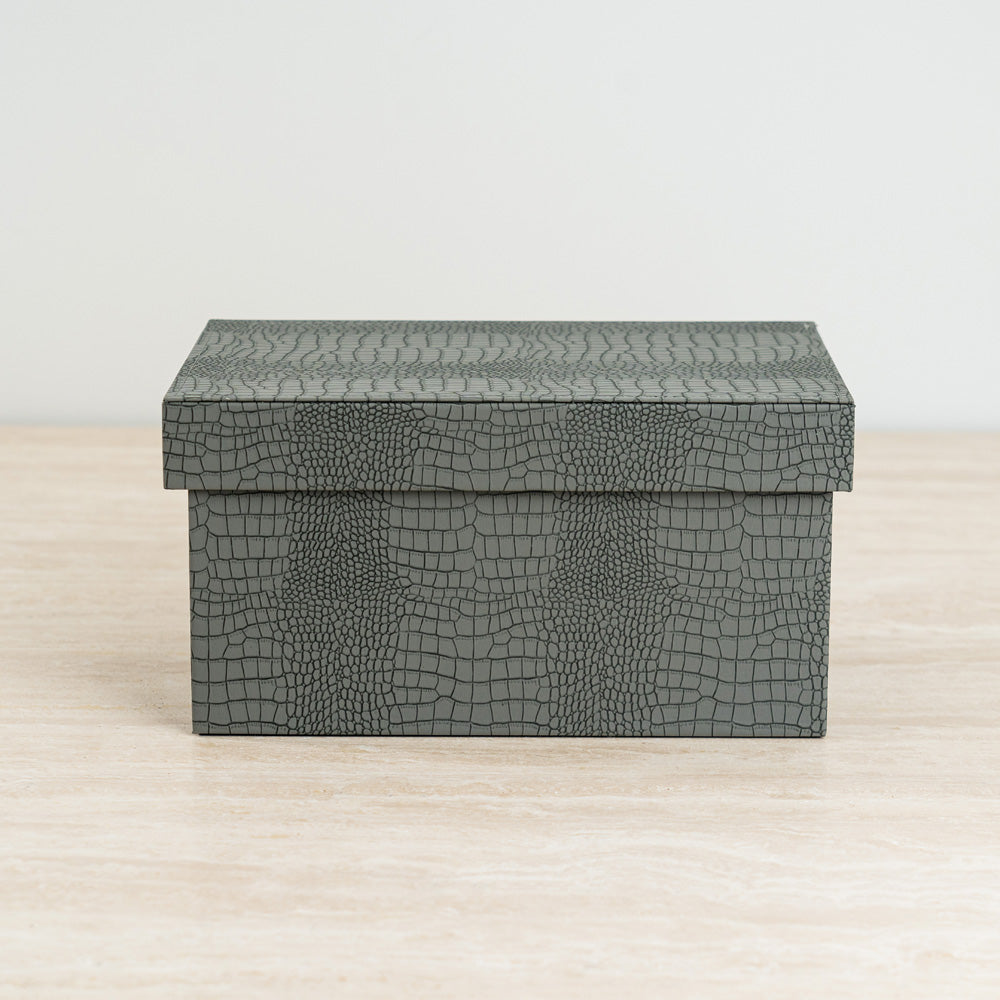 Designer storage box featuring a textured croc exterior and vibrant velvet interior