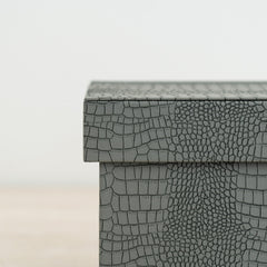 Statement jewelry organizer with crocodile detailing and rich orange velvet lining