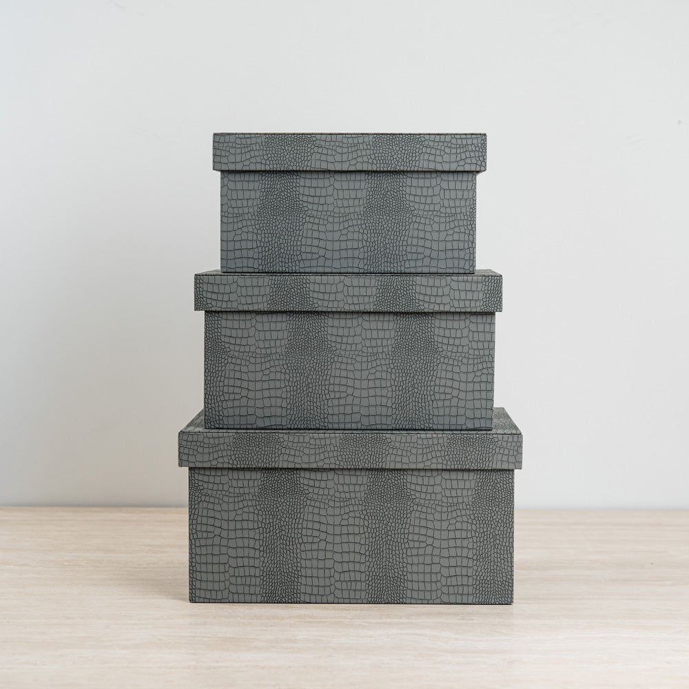 Blue crocodile jewelry box featuring a vibrant orange velvet interior for elegant storage.