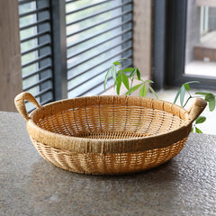 Modern yet timeless round bowl storage basket in plastic rattan, perfect for decorative and functional home storage.