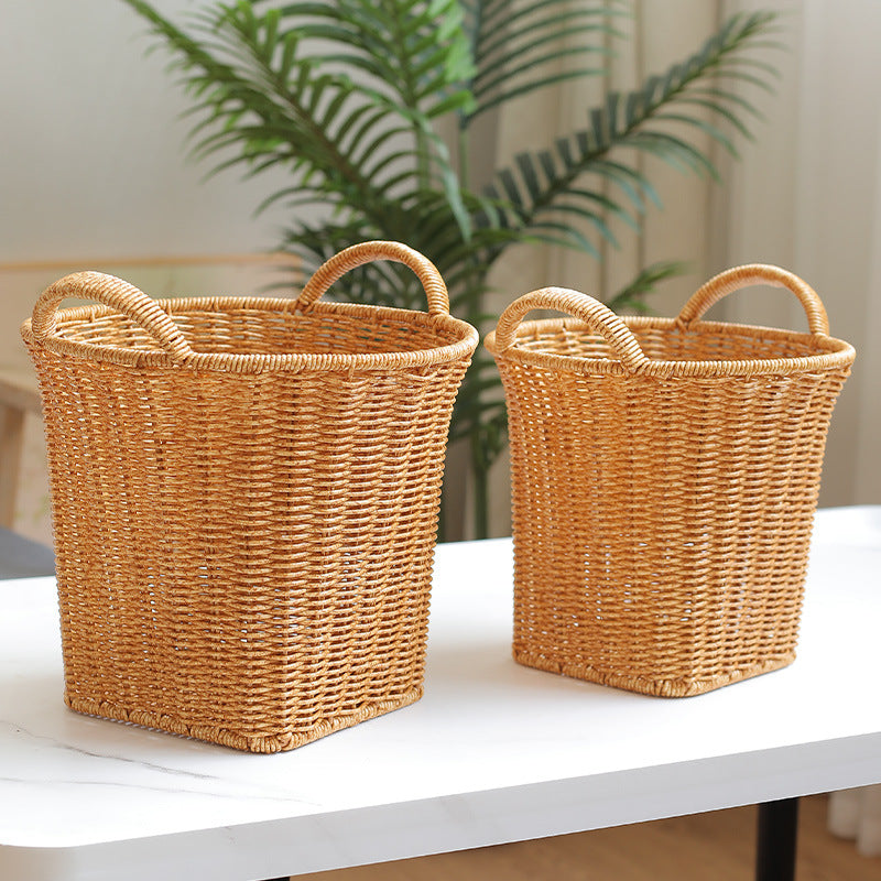 Set of decorative rattan-style storage baskets with handles, designed for versatile storage and sophisticated home décor.