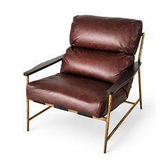 Industrial leather accent chair featuring saddle leather straps and brass stud detailing.