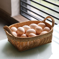 Oval decorative storage basket with strong handles, suitable for modern, traditional, or contemporary home interiors.