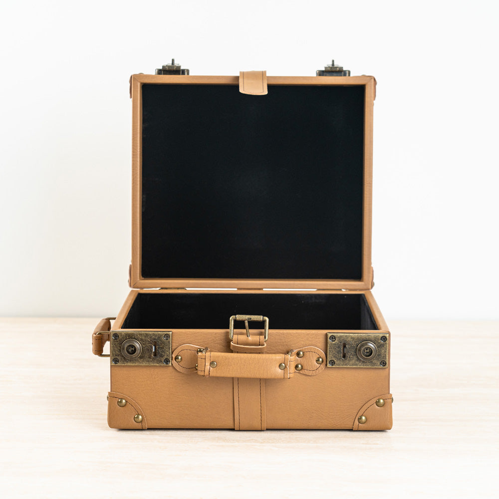 Designer storage box with vintage suitcase-inspired aesthetic.