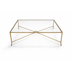 Contemporary coffee table with sculptural metal base and tempered glass top.