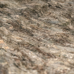 Close-up detail of the Otto Dining Table’s marble countertop and black base with curved design.