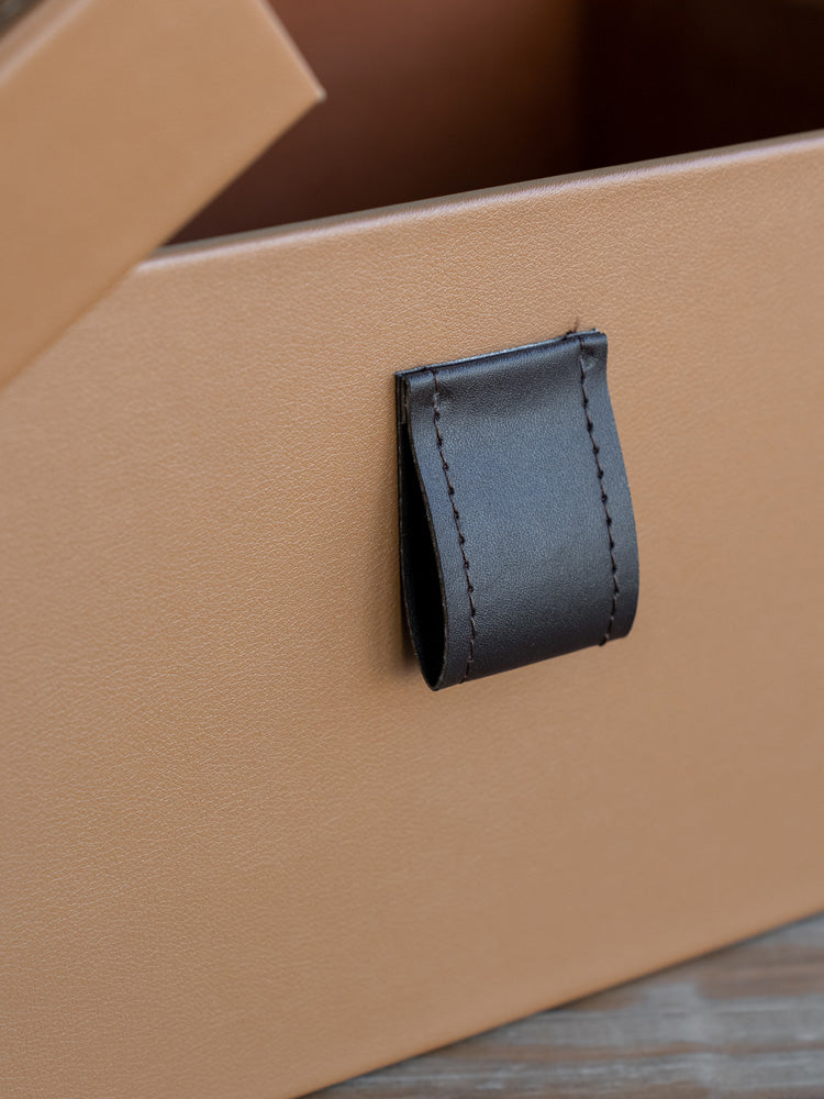 Stylish medium-sized PU leather storage box with plush velvet interior, perfect for storing everyday essentials or accessories on a vanity, desk, or shelf.