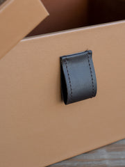 Stylish medium-sized PU leather storage box with plush velvet interior, perfect for storing everyday essentials or accessories on a vanity, desk, or shelf.