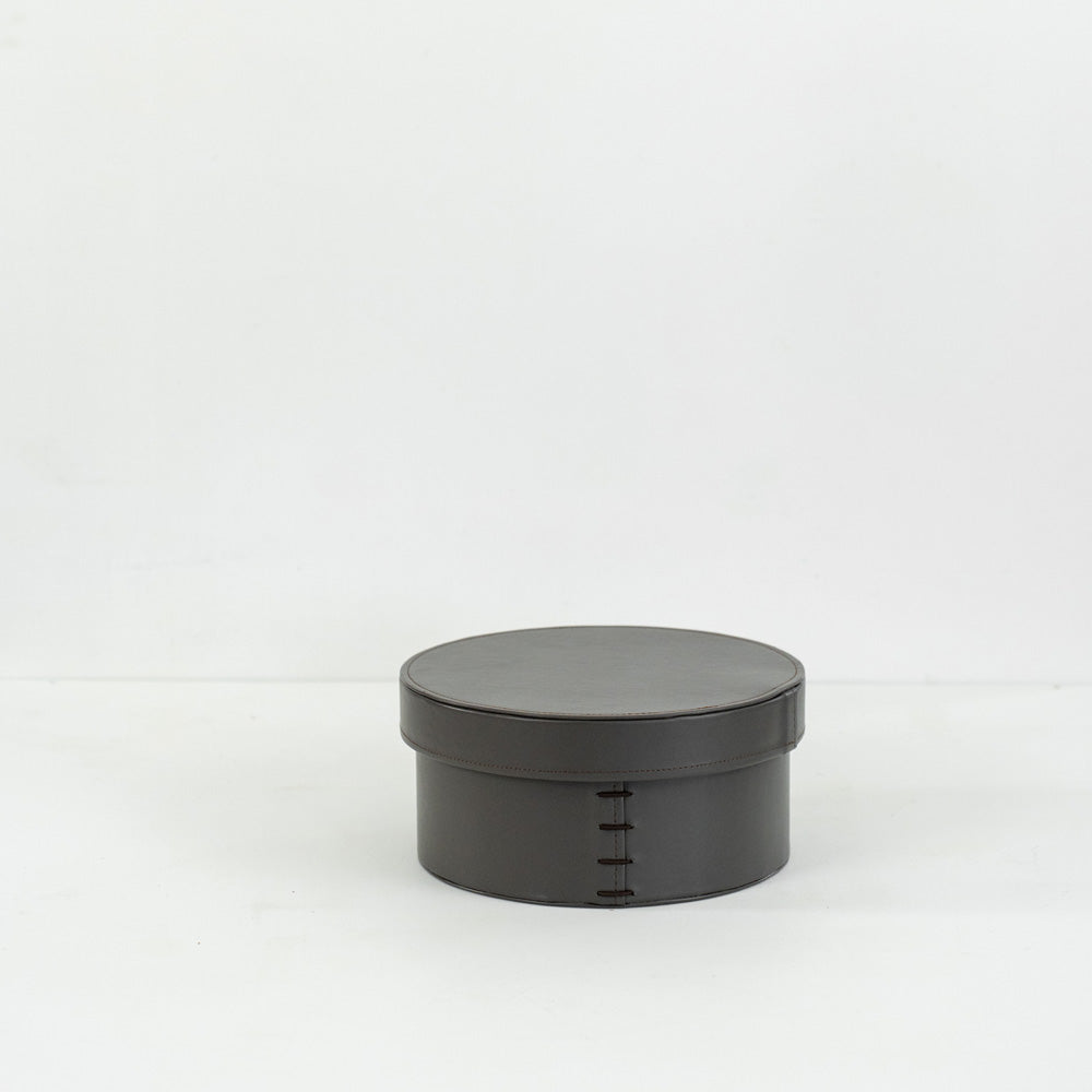 Premium round storage box made from hand-woven bridle leather, combining durability and style to organize accessories, keepsakes, or home essentials in modern and luxury interiors.