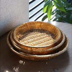Round plate-style storage basket made from durable plastic rattan, perfect for organizing toiletries, accessories, or small household items.