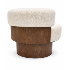 Contemporary boucle accent chair with rounded seat and 360-degree swivel.