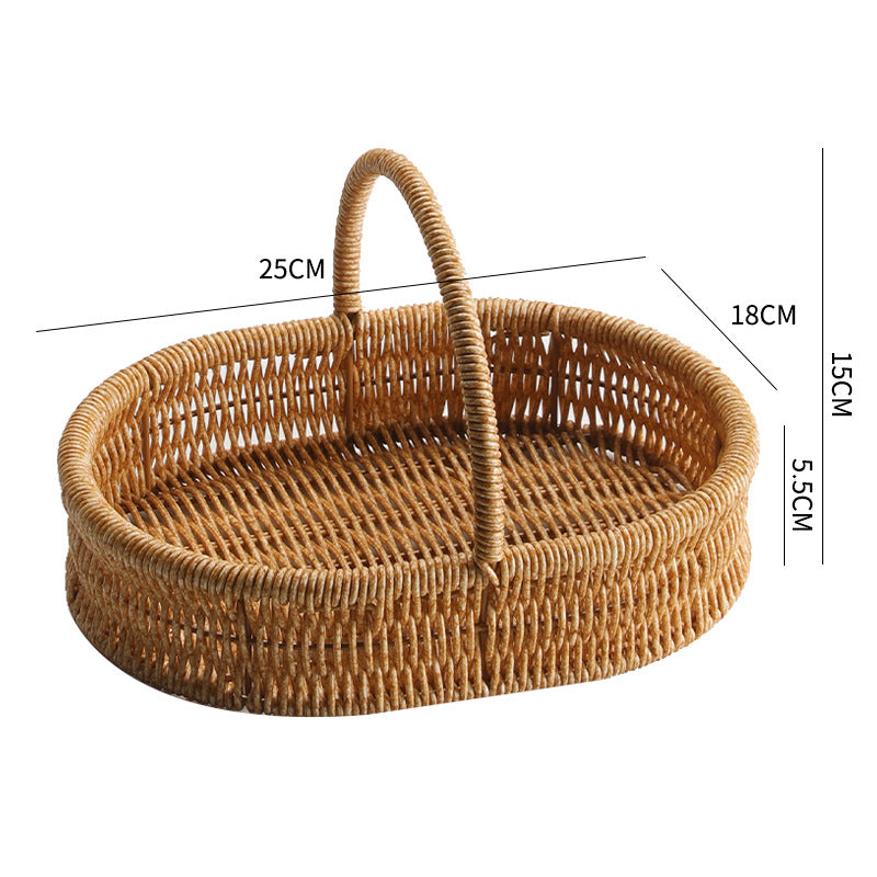 Small shallow oval plastic rattan basket with a sturdy handle, ideal for toiletries, accessories, or small decorative items.