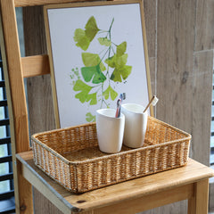 Sophisticated rectangular plastic rattan basket, blending durability with style for practical and decorative home storage.
