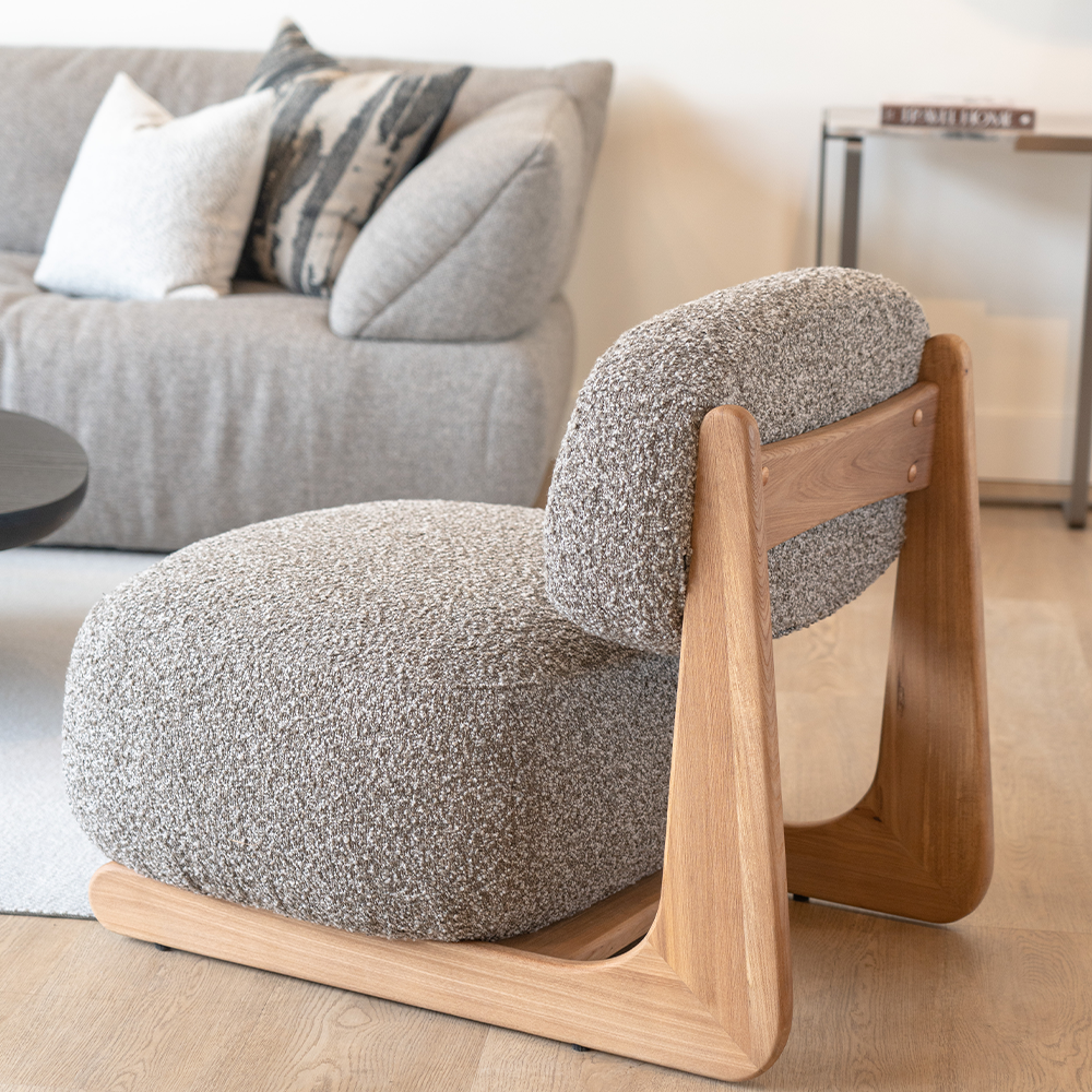 Elegant curved accent chair with soft cotton linen fabric and Elm wood accents, perfect for living room or bedroom.