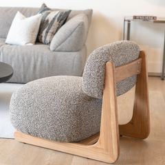 Elegant curved accent chair with soft cotton linen fabric and Elm wood accents, perfect for living room or bedroom.