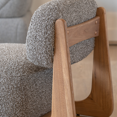 Plush cotton linen armchair featuring a sleek curved design and natural Elm wood frame for luxury home seating.