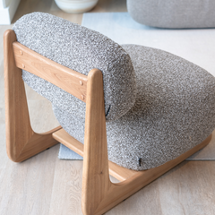 Scandinavian-inspired lounge chair with curved silhouette, cotton linen upholstery, and warm Elm wood finish.