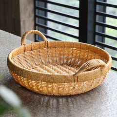 Round bowl-style storage basket featuring a thick border and handles, combining practicality with classic elegance.