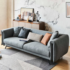 Designer Tindra 3-Seater Sofa in bold blue cotton-linen fabric with sleek brushed titanium legs, blending classic design with modern elegance.