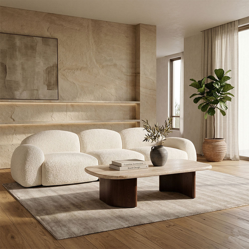 Modern living room with a white sofa, wooden coffee table, and decorative elements.