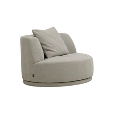 Side view of the Umea Swivel Armchair showcasing its elegant curved silhouette, low-profile design, and soft, inviting upholstery in a contemporary interior setting.