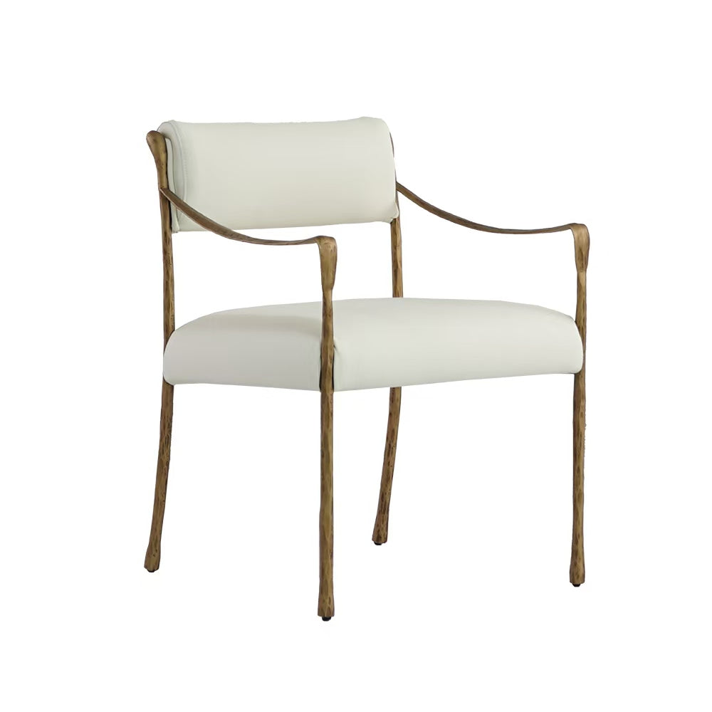 Luxurious armchair in soft white fabric with solid forged golden iron frame. A refined statement piece combining comfort, elegance, and timeless artistry.