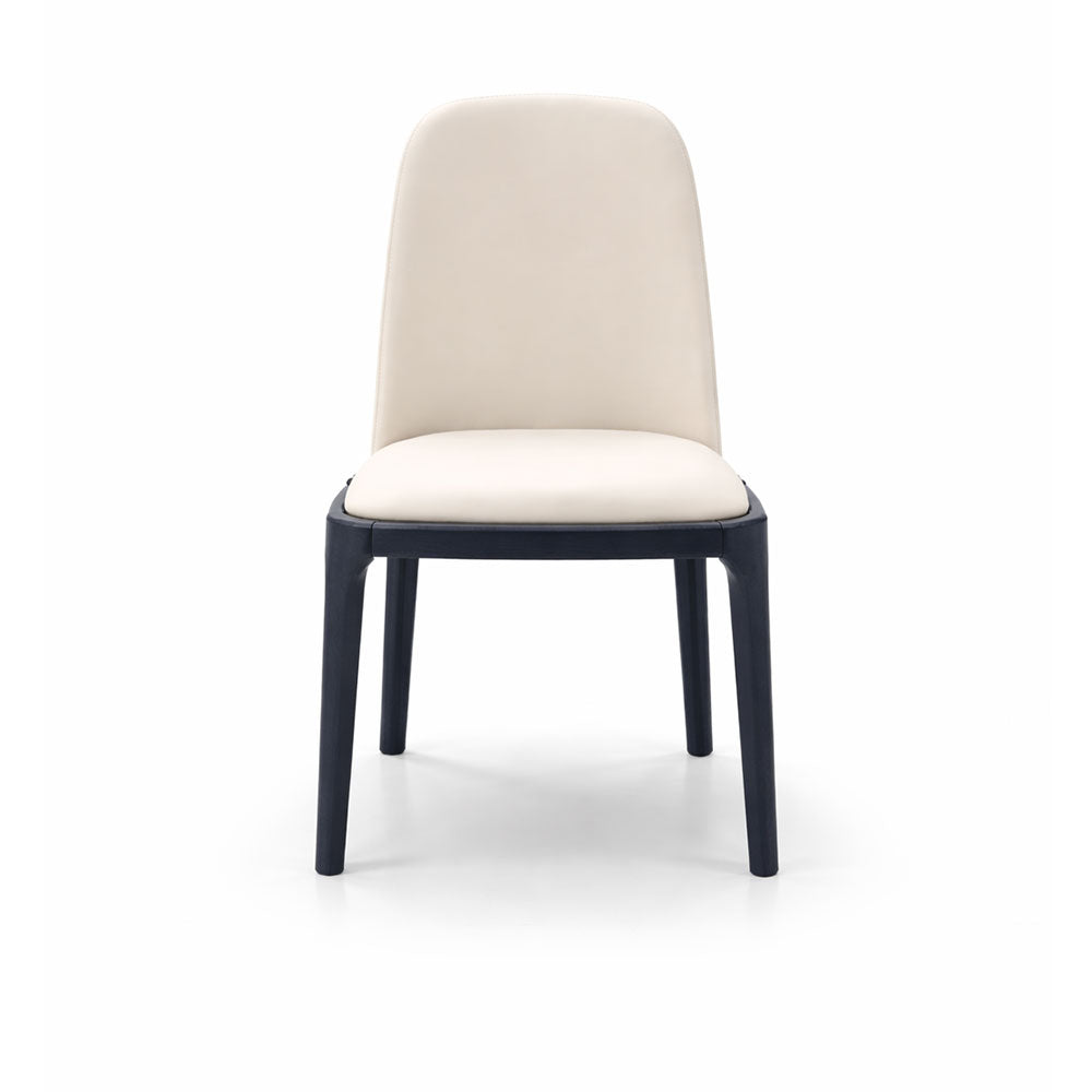 Classic dining chair upholstered in cream microfiber leather with dark contrast legs, offering comfortable and stylish seating for modern dining spaces.