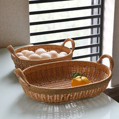 Versatile oval storage basket in durable plastic rattan, combining practicality with timeless sophistication.