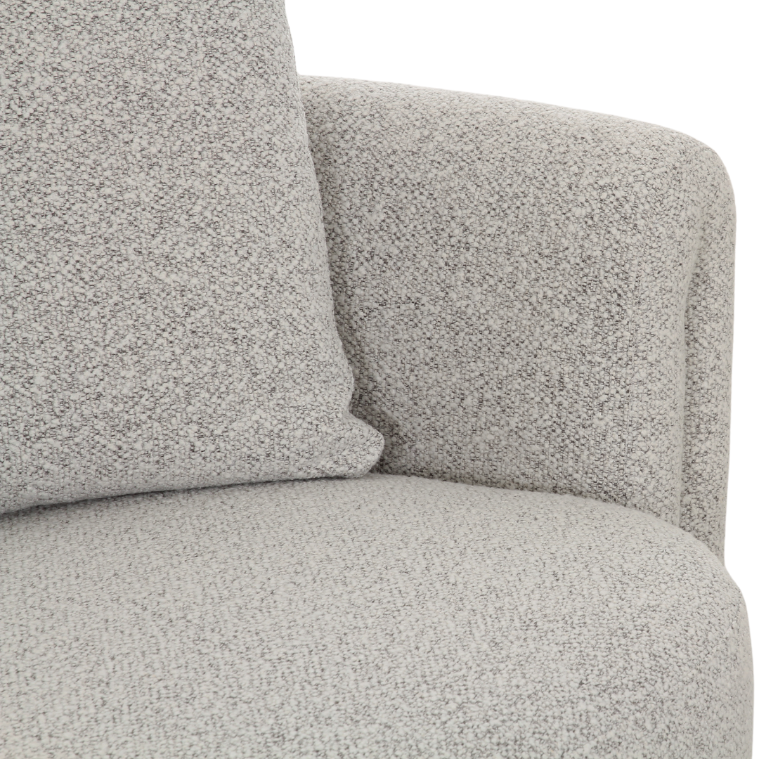 Designer armchair with soft boucle upholstery, stylish grey finish, and comfortable modern seating